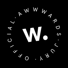 A black circular badge featuring the letter 
